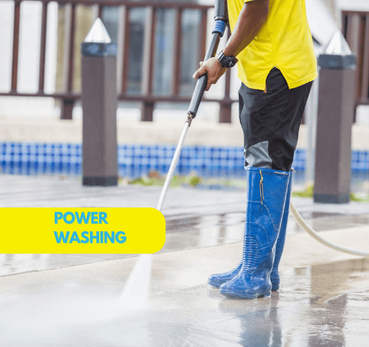 High-pressure washing service cleaning concrete driveway and removing mold mildew from exterior surfaces of Sarasota residential property