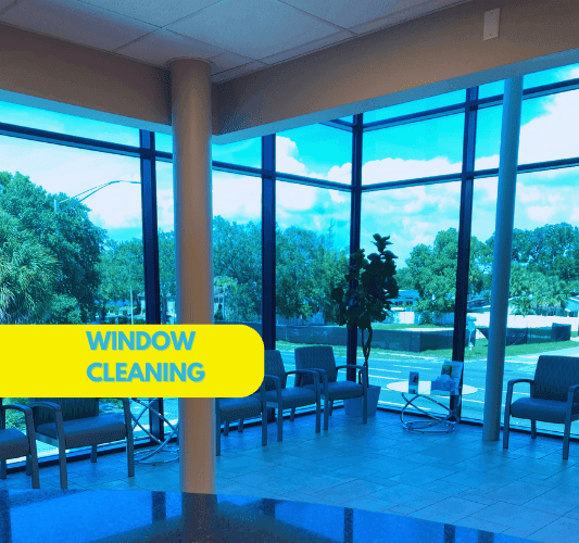 Professional window cleaner using water-fed pole system for streak-free cleaning of residential windows in Sarasota beachfront property